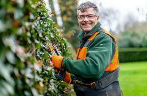 Gardner - Man cutting hedge